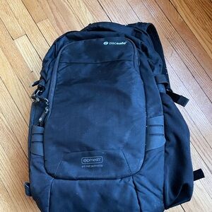 PacSafe travel safe crossbody laptop backpack with camera compartment